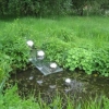 Silver balls leading into the pond