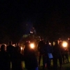 The torchlight procession gathering around the bonfire