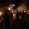 The first torches are thrown onto the bonfire