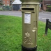 Gold-painted pillar box in Station Road in honour of Peter Charles' Olympic gold medal in the Equestrian section