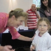Remi Fewing receiving the Children's cup for Finest Children's exhibit for her home-made birthday card